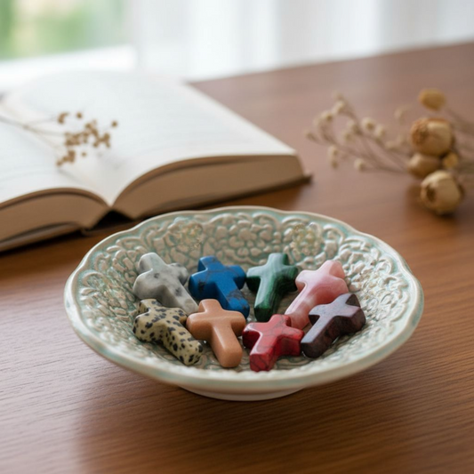 natural stone pocket cross beside an open Bible