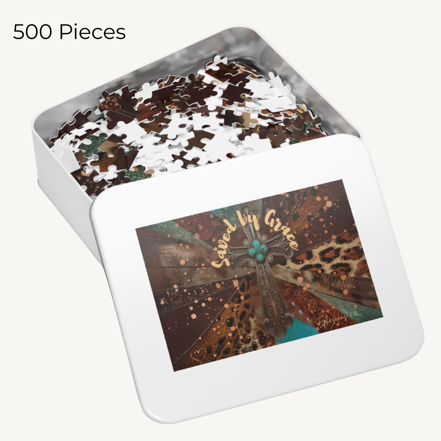 Jigsaw puzzle with 500 pieces in a tin box featuring a cross and 'Saved by Grace' text.