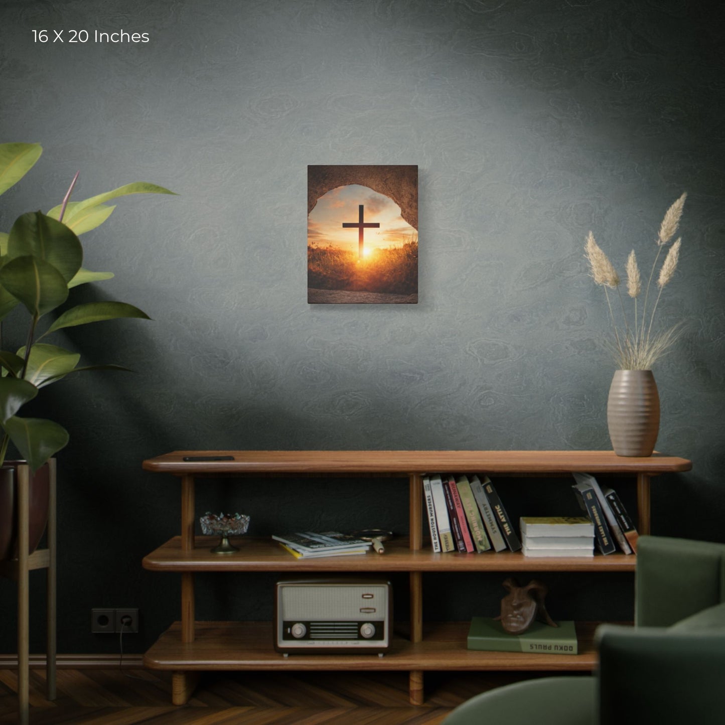 Wall art of a cross against a sunset sky in a room with a shelf and decor.
