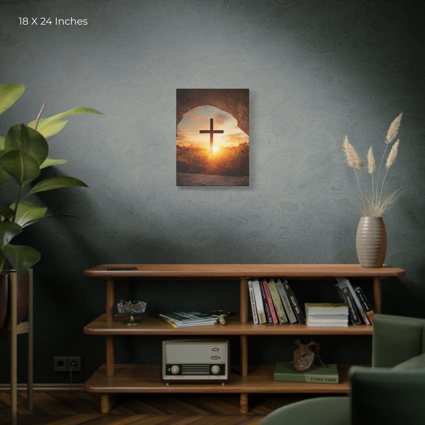 Framed artwork of a cross against a sunset sky on a wall above a wooden shelf with books and decor.
