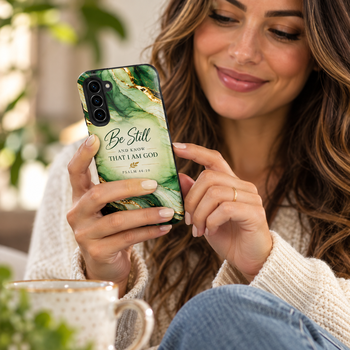 Green botanical Samsung Galaxy case with ‘Be still and know’ Scripture artwork, shown against a leafy background