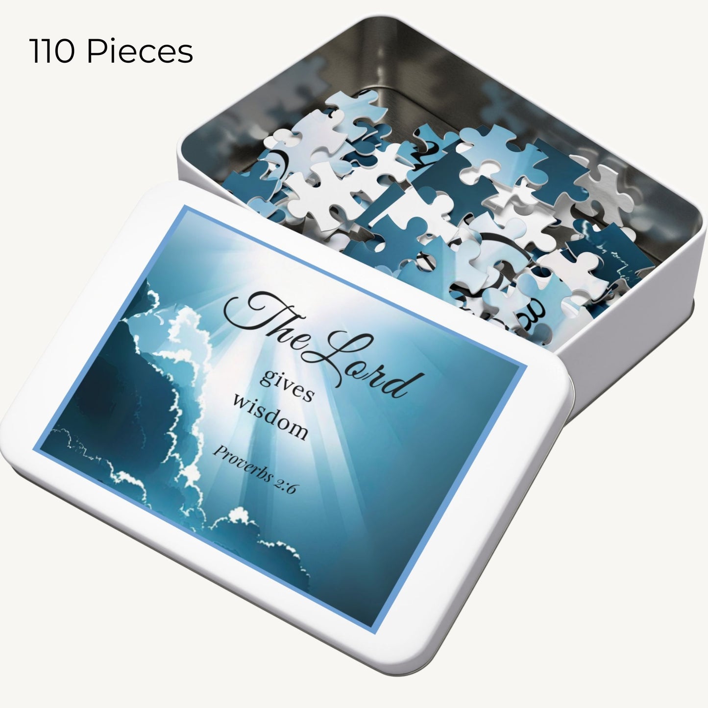 Jigsaw puzzle set with 'The Lord gives wisdom' quote on a tin box