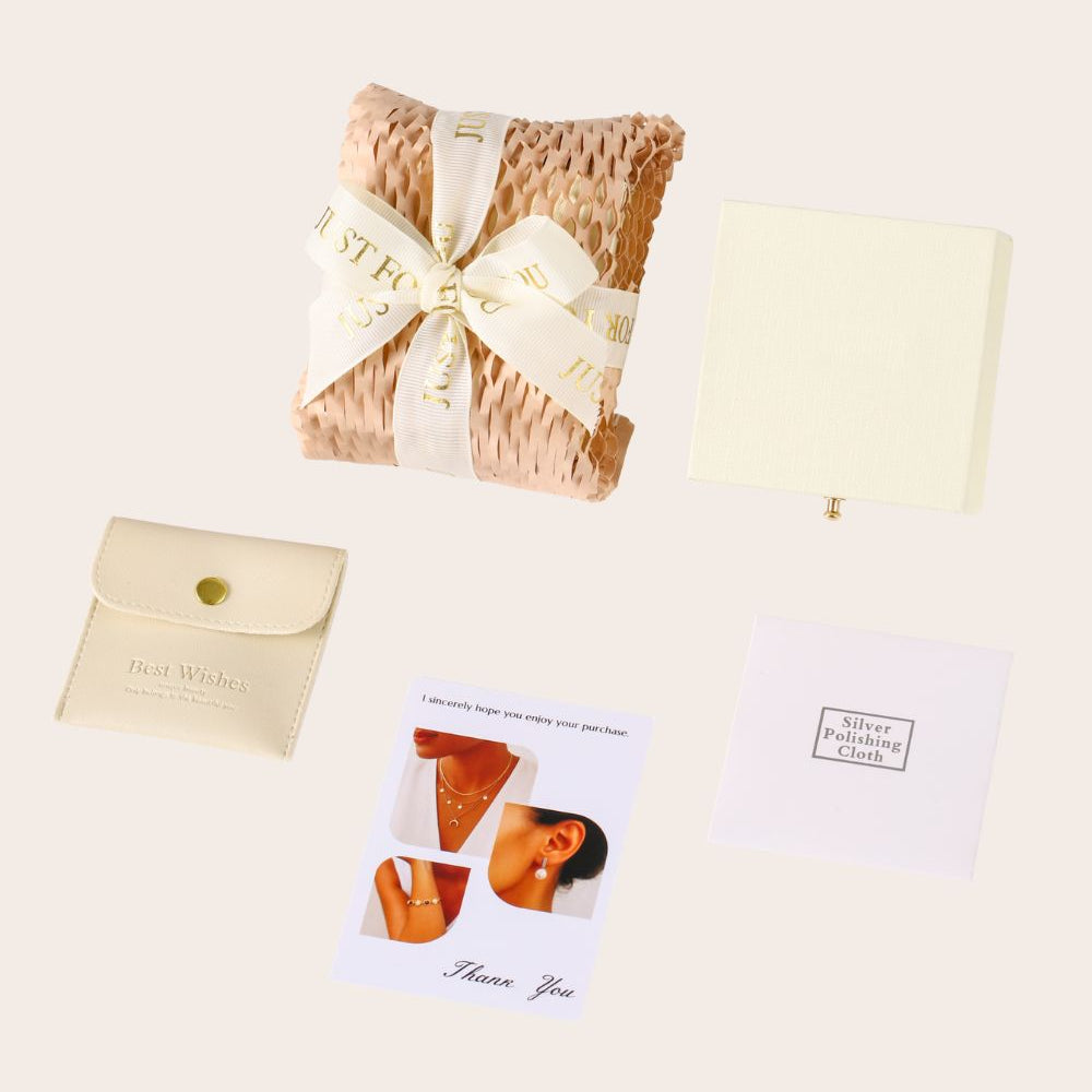 Gift set with a cushion, card, and small pouch on a beige background