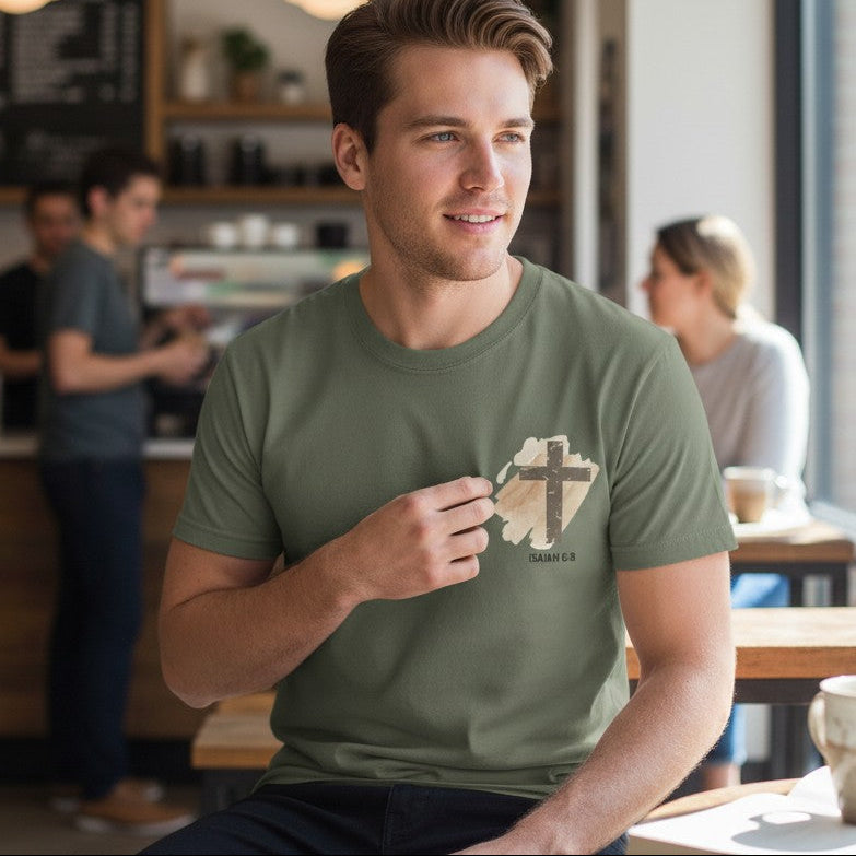 Man wearing a green t-shirt with a logo in a coffee shop