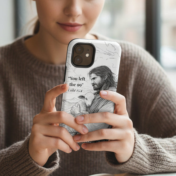 Woman holding a phone with a Jesus design in a cafe