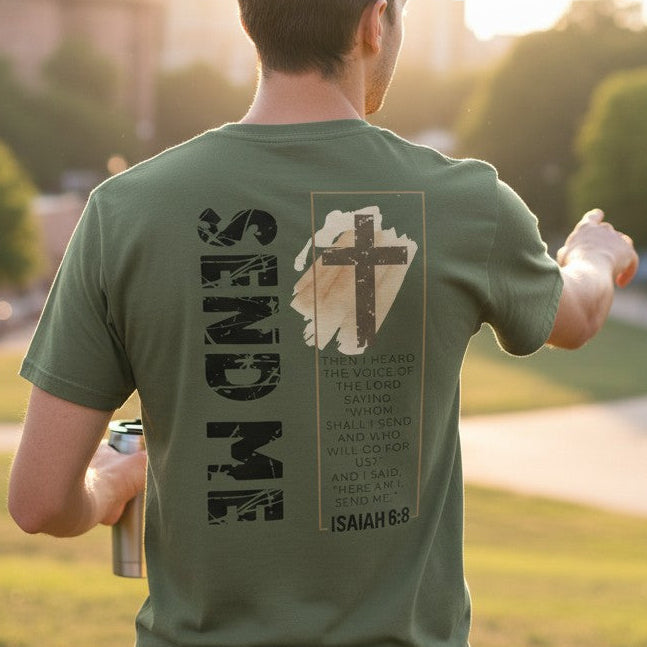 Person wearing a green t-shirt with text and graphics, standing in a park with trees and buildings in the background.