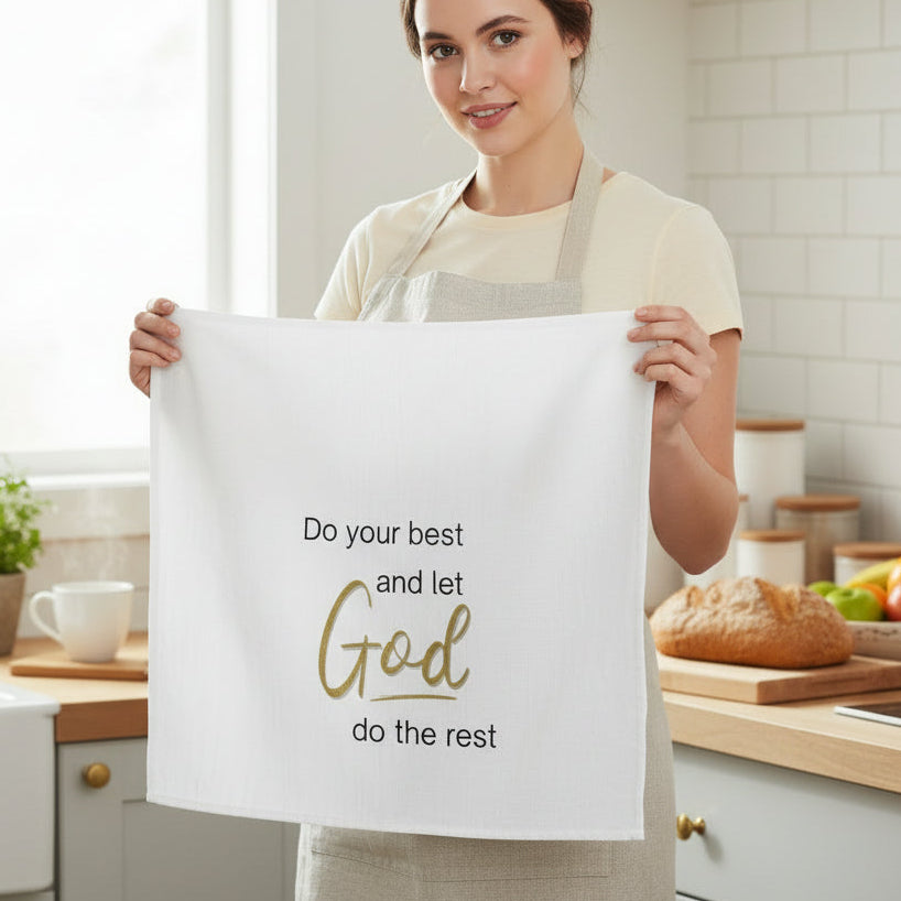 Woman holding a towel with a motivational quote in a kitchen