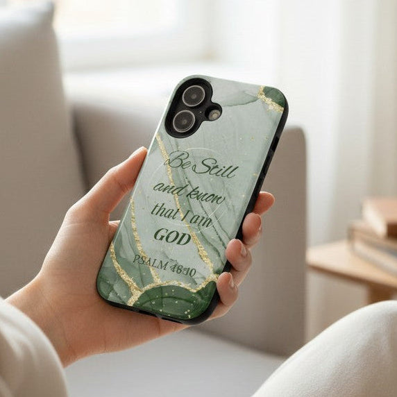 Person holding a phone with a green marble design and inspirational quote