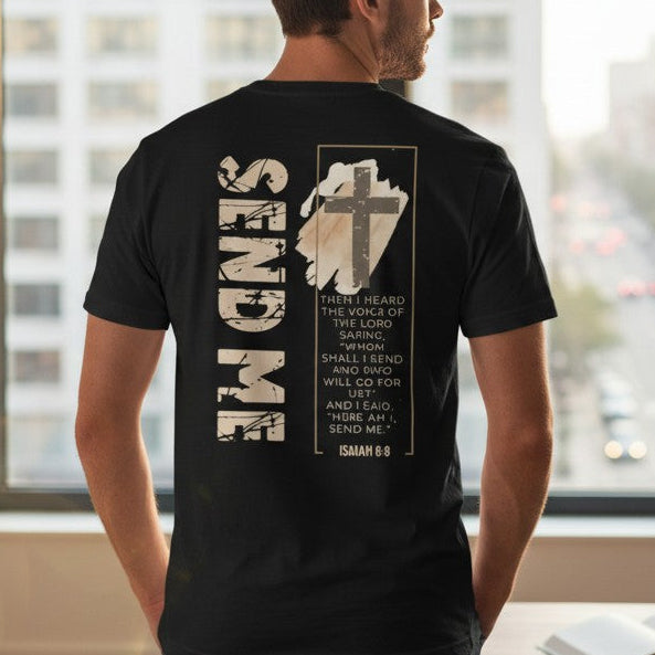 Man wearing a black t-shirt with text and graphics, standing in a room with large windows.