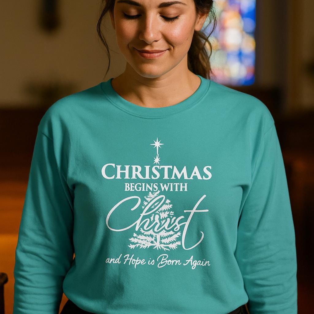 Person wearing a teal sweatshirt with a Christmas message