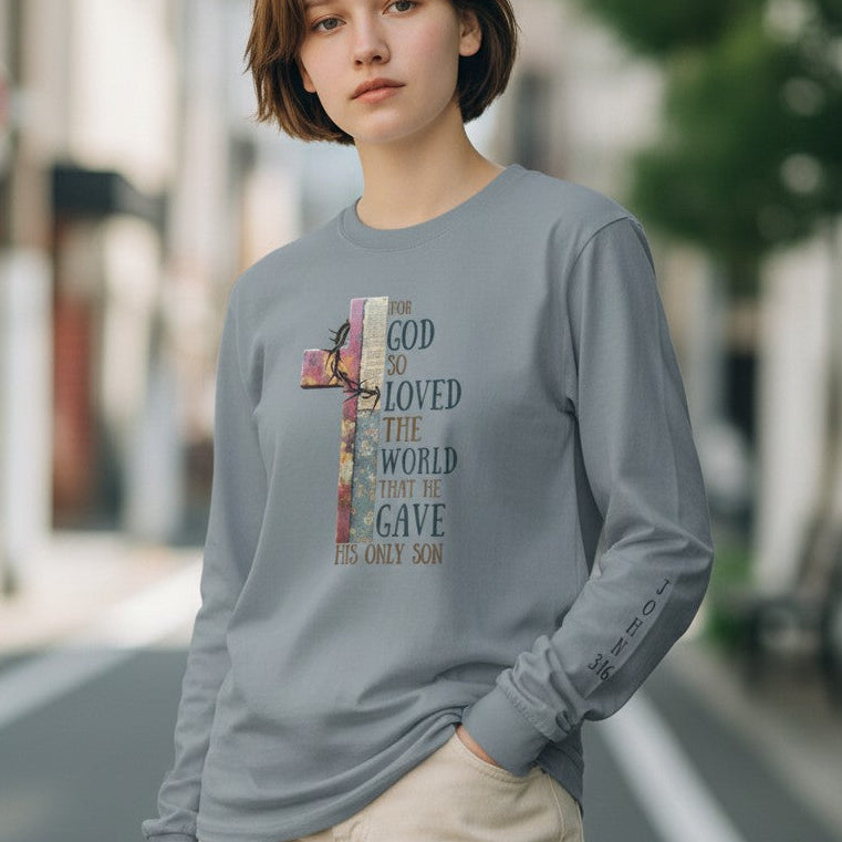 Person wearing a gray long-sleeve shirt with a colorful graphic design on a city street.