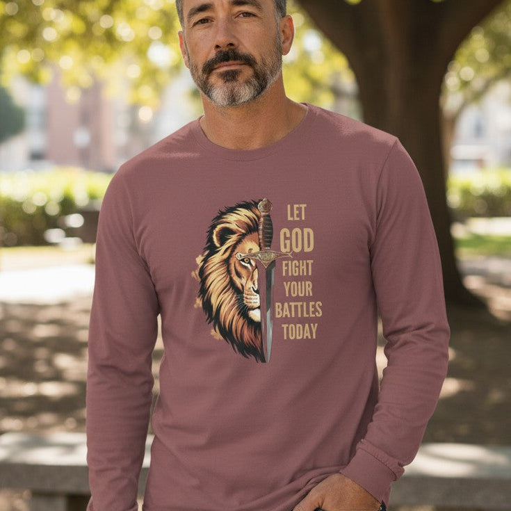 Man wearing a long-sleeve shirt with a lion graphic and text in an outdoor setting