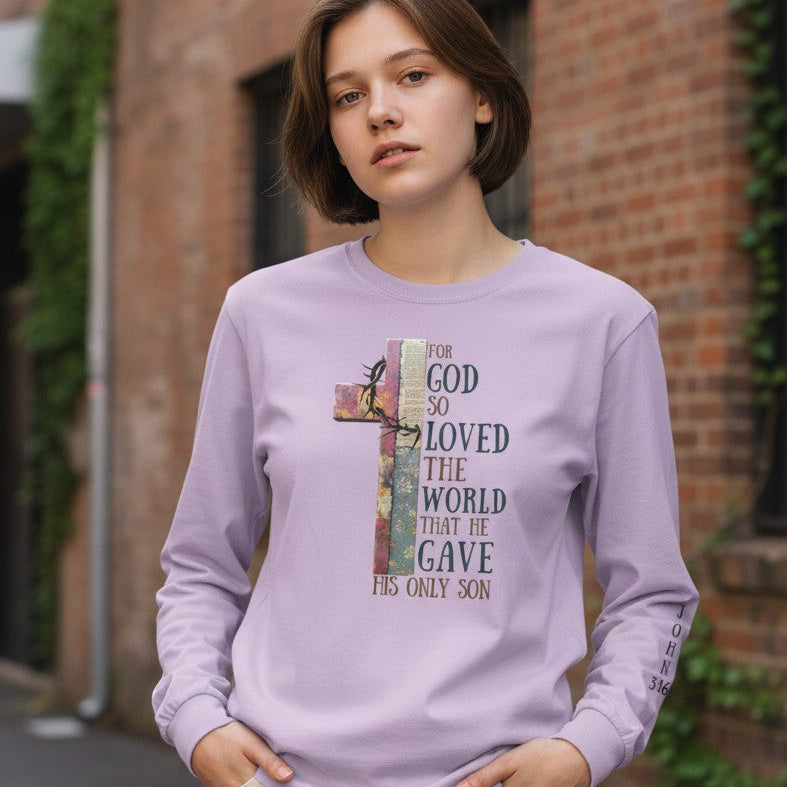 Person wearing a purple long-sleeve shirt with a text design in an urban setting
